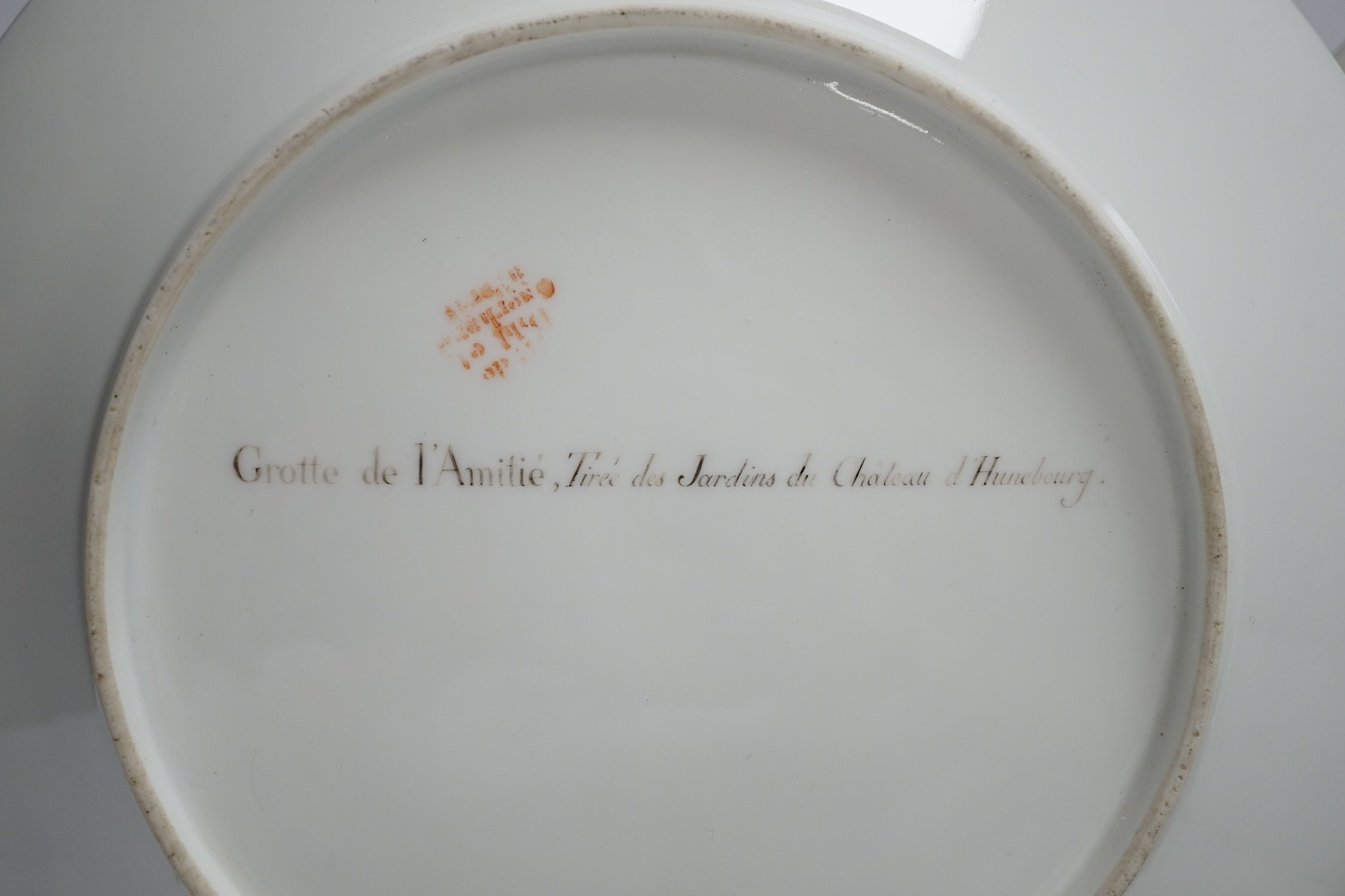 A pair of early 19th century Paris porcelain titled landscape and gilt decorated dishes, 24.5cm diameter